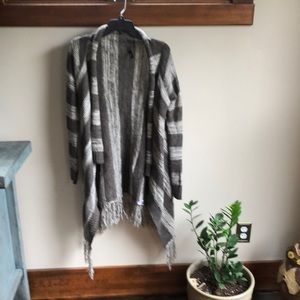 Gorgeous Elan shawl / sleeves sweater with fringe adorning bottom.